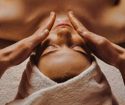 a woman getting a facial massage at a spa