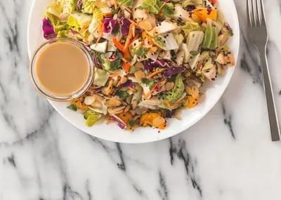 chicken-salad-and-sauce-on-white-plate