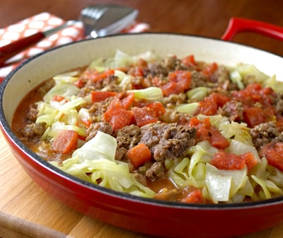 a bowl of cabbage, beef, and tomatoes