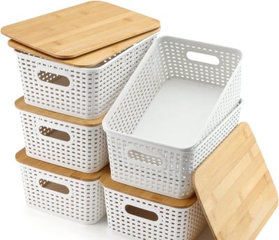 a stack of white baskets with wooden crates