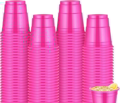 a group of pink cups with a cup of coffee and a cup of coffee