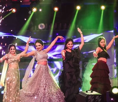 a group of women in traditional indian attire performing a dance