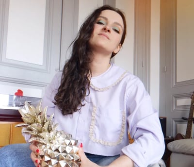 a woman sitting on a chair holding a pineapple chemise vintage couture