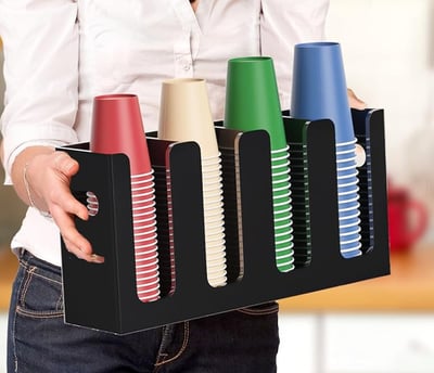 a woman holding a tray with a tray of hair products