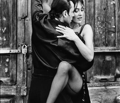 a man and woman dancing in a dance pose