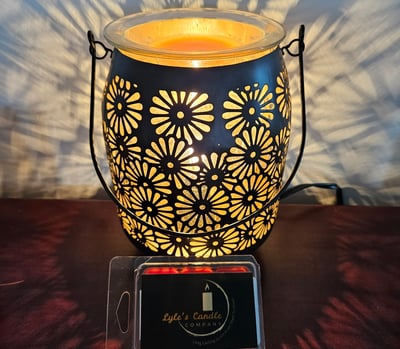 a candle lit up with a candle in a glass jar
