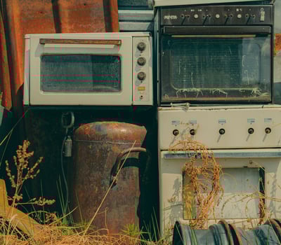 a kitchen with a stove top oven and a microwave, appliances, junk removal