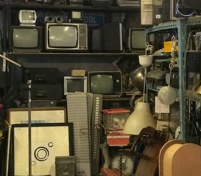 a room with a lot of different types of televisions, electronics, e-waste, ewaste