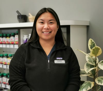 woman with long black hair a name tag on her upper right side