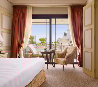 A luxurious suite bedroom at Hotel de Paris in Monaco