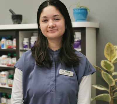 picture of woman with dark hair wearing blue scrubs