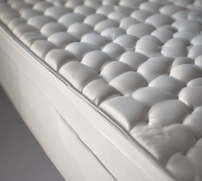 a close up of a mattress with a white background