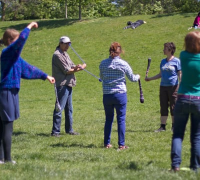 The Pyroneer teaching group Poi lesson in a park./