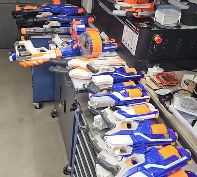 a bunch of nerfet guns are lined up on a table