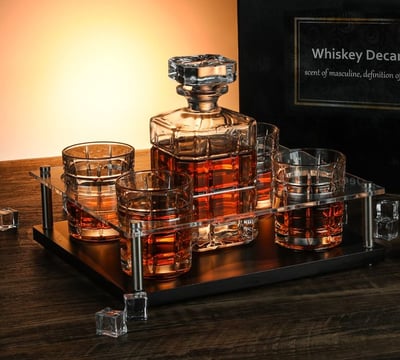 a set of whiskey glasses and a bottle of whiskey