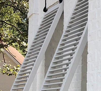 exterior bahama shutters showing a faux tilt rod design