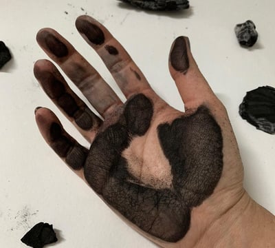 a person's hand painted with black Expressive Arts therapy Ukraine