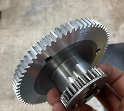 hand holding a machined gear
