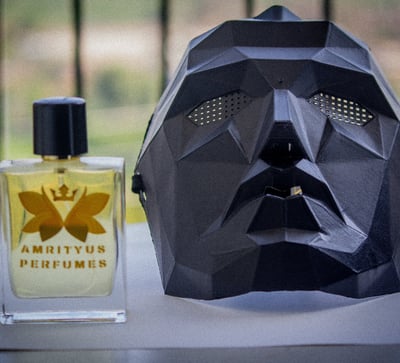 a mask mask and a perfume bottle on a table