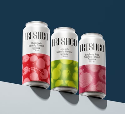 three cans of fresh fruit juice on a table
