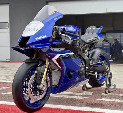 the new Yamaha R9 blue motorcycle parked in front of a building