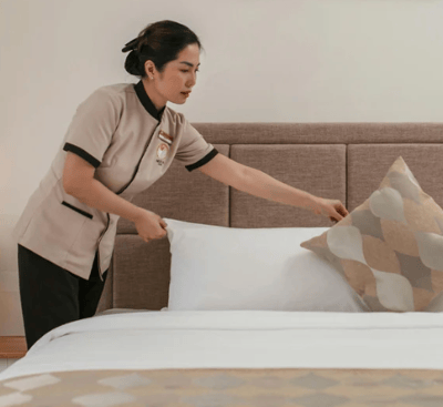 "Professional housekeeping preparing a bedroom as part of Vision Immo Bali’s property management