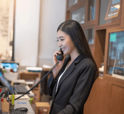 Concierge answering a guest call — part of Vision Immo Bali’s personalized villa management service