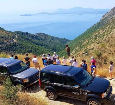 a group of people standing on a hill top