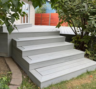 A composite stair case that has skirting around it.