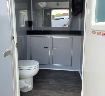 inside a women's' bathroom in a portable luxury restroom trailer at a wedding