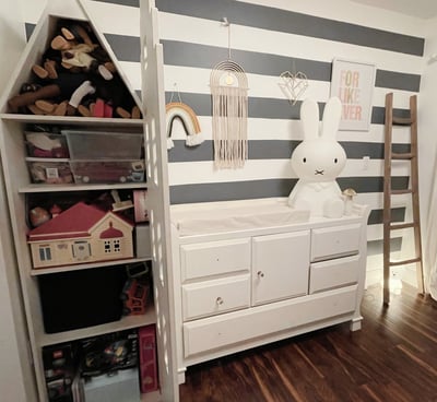 Organized kids’ room with toy shelves, dresser, and playful minimalist decor.