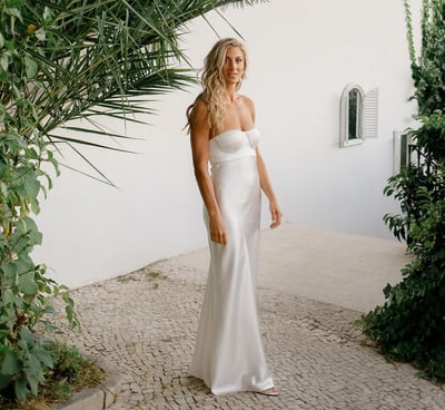 Bride in a white wedding dress with loose long hair and beach waves