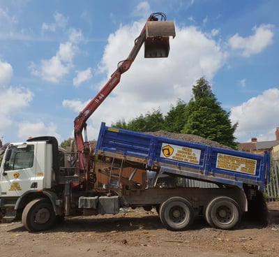grabber about to unload top soil in stourbridge