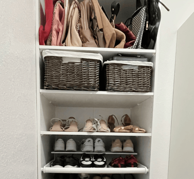 Closet shelves neatly organized with handbags, woven baskets, and rows of shoes.