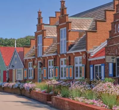 a row of houses with blue shutters and red brick walls