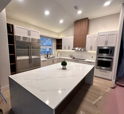 White kitchen makeover with subway tile backsplash and stainless steel appliances — expert remodelin