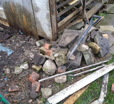 a pile of rubble and rubble in a yard