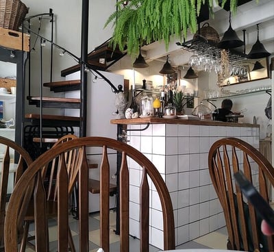 a restaurant with a table and chairs and a staircase