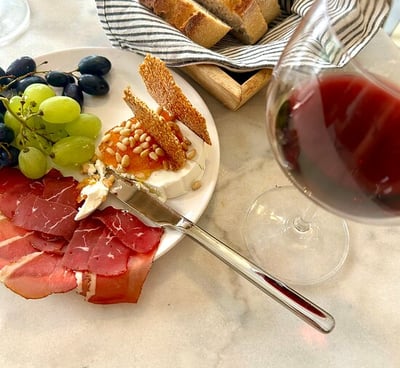 a plate of food and wine glasses on a table