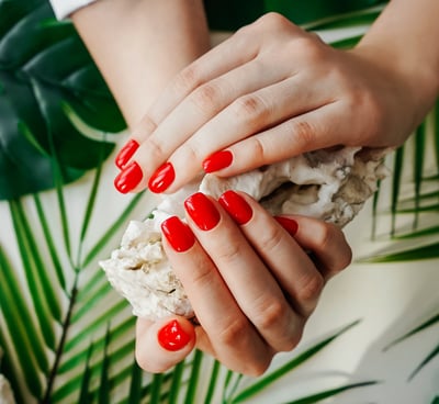 a woman's hands with red nails and red nails