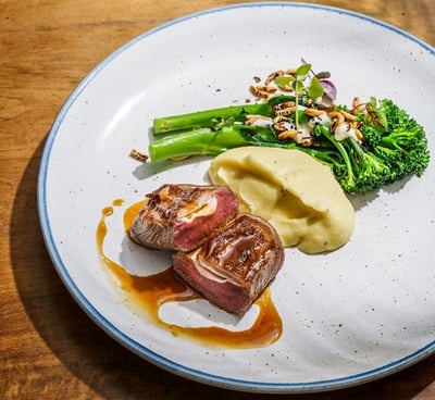 a plate of food with meat and vegetables