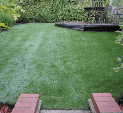 a backyard with a lawn and a deck