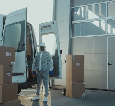 a man in a white coat is walking out of a van