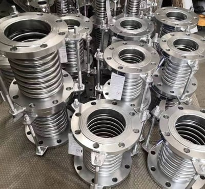 a bunch of metal pipe flanged flanges and a lot of metal