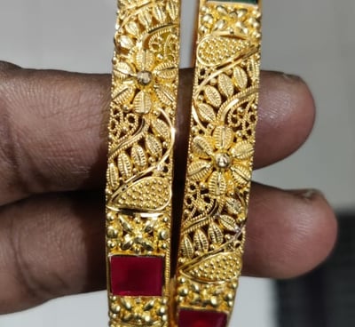 pair of gold colored bangles