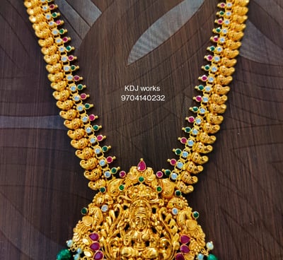 a gold necklace with a godess lakhsmi