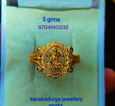 a gold ring with a godess lakhsmi on it