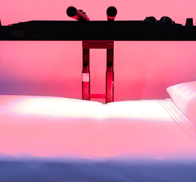 a red light therapy bed with a red heat lamp