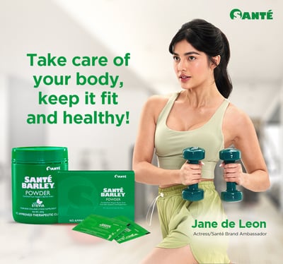 a woman in a green tank top and a pair of dumbs