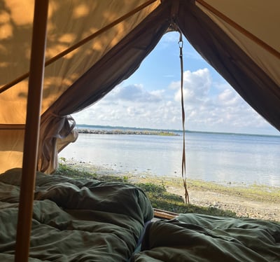 a tented tent with a view of the ocean